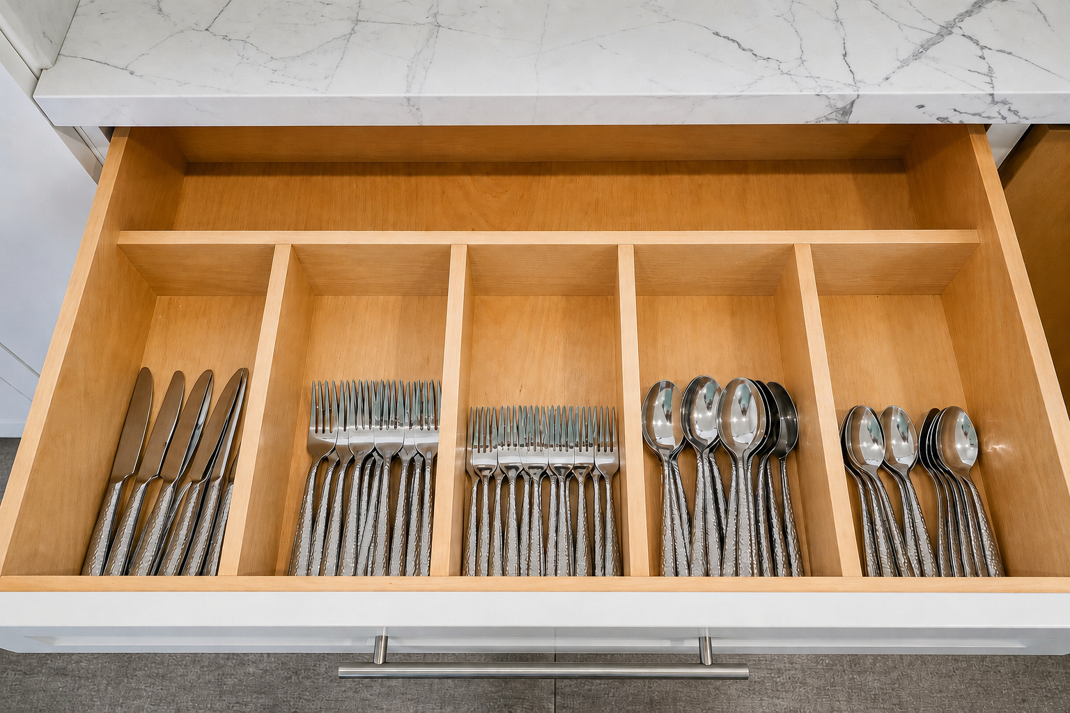 Complete flatware set for 16 in a wooden drawer