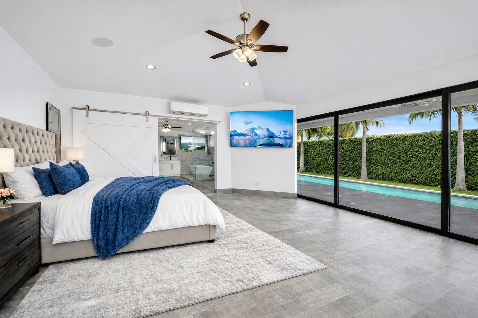 Bedroom 1 ocean view king suite with 86-inch smart TV