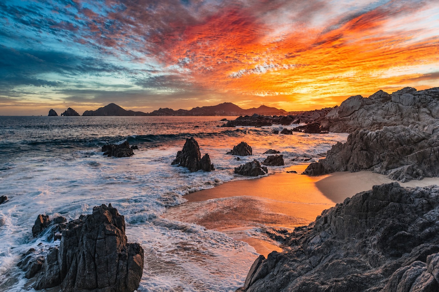 Sunset over a hidden rocky beach in Cabo
